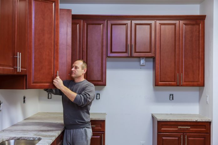 Carpenter working on new kitchen cabinets